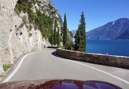 Cabriolet driving on Lake Garda in Italy