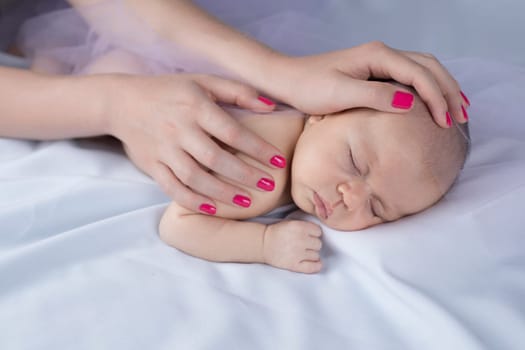 Newborn baby hand holding mother
