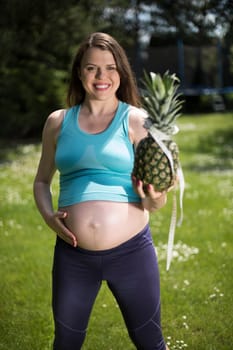 Beautiful pregnant woman at fitness gym relaxed