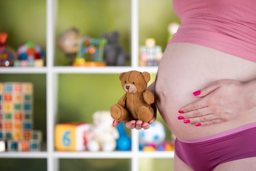 Teddy bear toy, pregnant woman