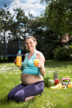 Beautiful pregnant woman at fitness gym relaxed