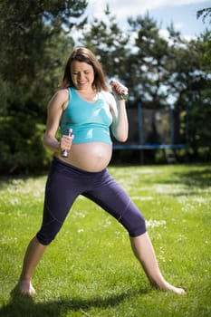 Beautiful pregnant woman at fitness gym relaxed