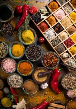 Variety of wooden box, spices and herbs on kitchen table