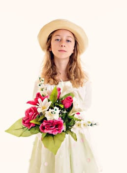 nice girl with blond hair in white dress and straw hat with bouquet of flowers