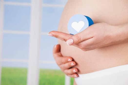 Pregnant woman holding a heart