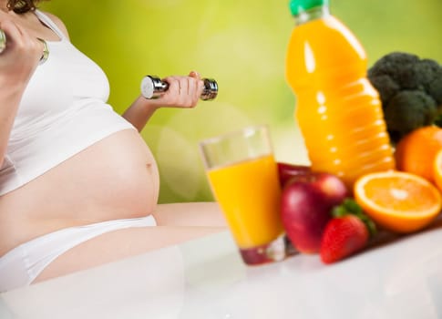 Pregnant woman with fruit and vegetables
