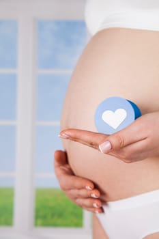Pregnant woman holding a heart