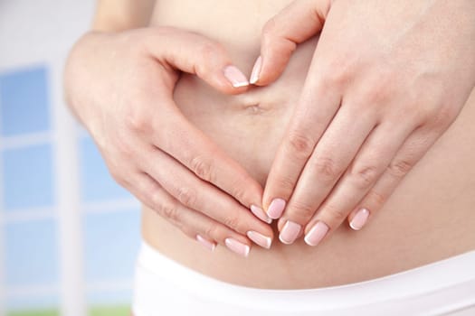 Pregnant woman holding a heart