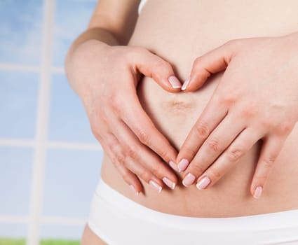 Pregnant woman holding a heart