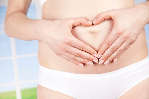 Pregnant woman holding a heart