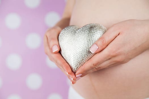 Pregnant woman holding a heart