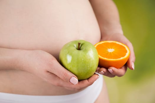 Pregnant woman with fruit and vegetables