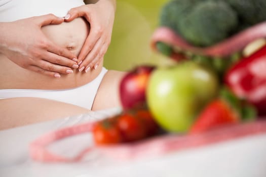 Pregnant woman with fruit and vegetables