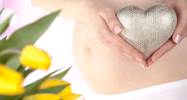 Pregnant woman holding a heart