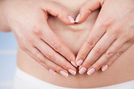 Pregnant woman holding a heart