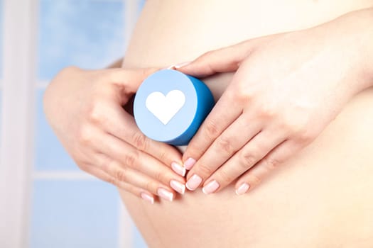 Pregnant woman holding a heart