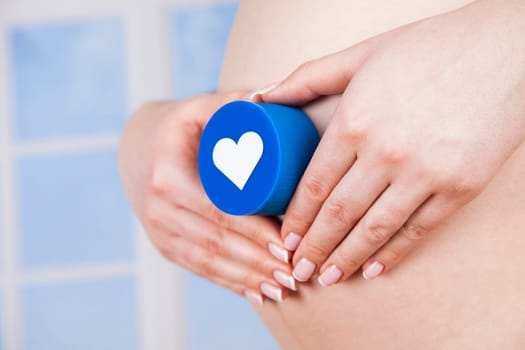 Pregnant woman holding a heart