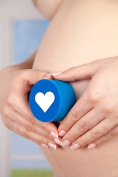 Pregnant woman holding a heart