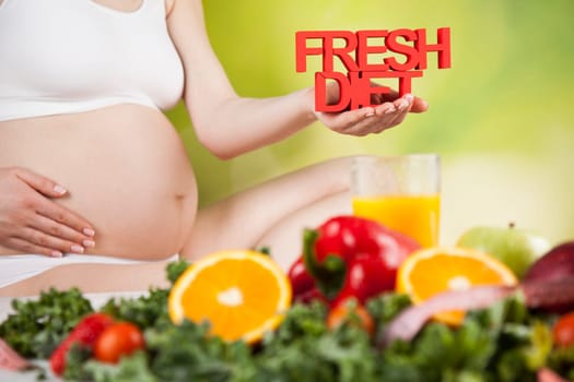 Pregnant woman with fruit and vegetables
