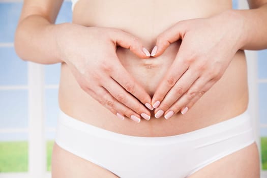 Pregnant woman holding a heart