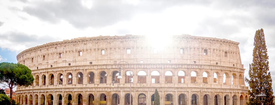 view of the Colosseum in Rome with the sun in backlight