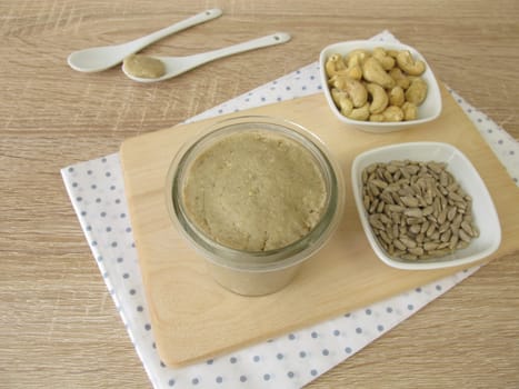 Homemade vegan nut butter from cashews and sunflower seeds in a glass