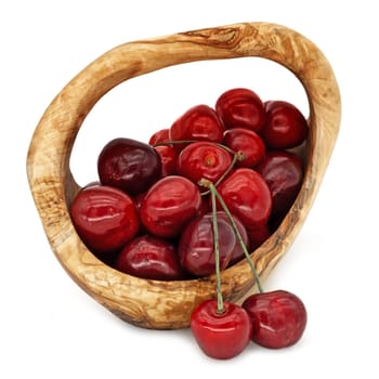 Cherries in a wooden basket,red fruit isolated with a white background