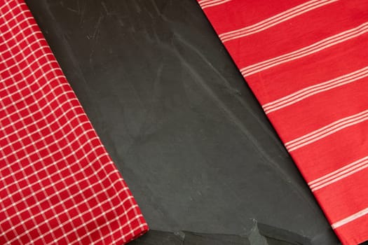 Red checkered and striped tablecloth on massive slate plate. Template for design menu card and chalkboard. Space for designer.