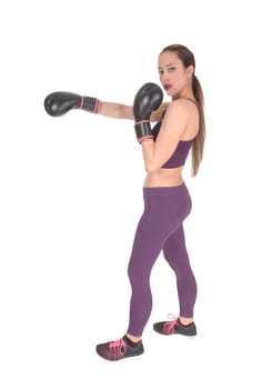 A full body image of a woman boxing and in workout outfits standing.isolated for white background.
