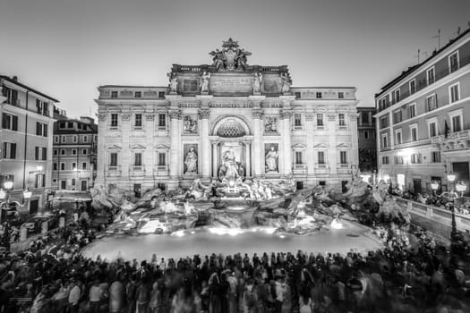 Rome Trevi Fountain or Fontana di Trevi at dusk, Rome, Italy. Trevi is the largest Baroque, most famous and visited by tourists fountain of Rome. Black and white image.