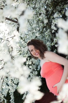 Spring, Young beautiful pregnant woman in the Orchard