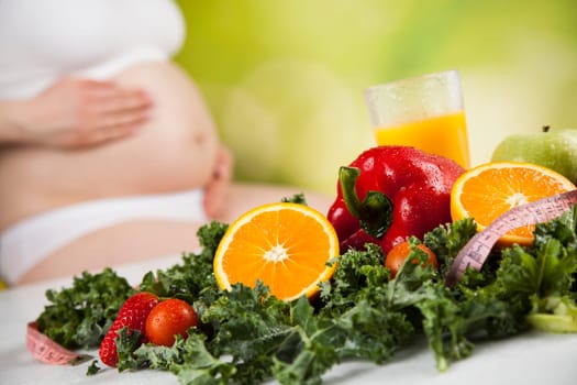 Pregnant woman with fruit and vegetables