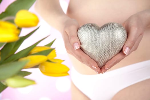Pregnant woman holding a heart