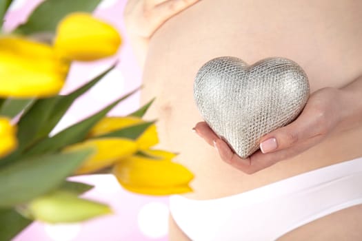 Pregnant woman holding a heart