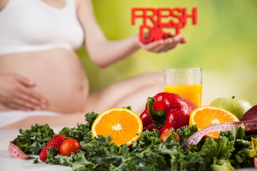 Pregnant woman with fruit and vegetables