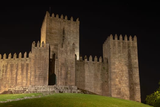 Medieval castle in Guimaraes city at night, Norte region of Portugal.