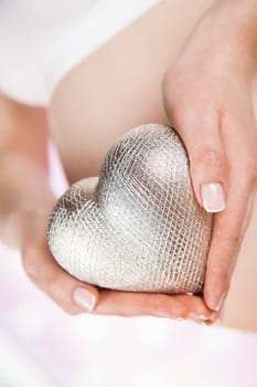 Pregnant woman holding a heart