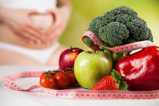 Pregnant woman with fruit and vegetables