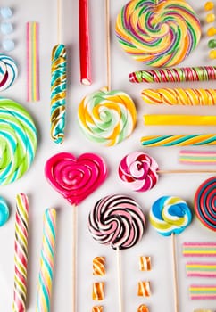 Colorful lollipops and different colored round candy and gum balls