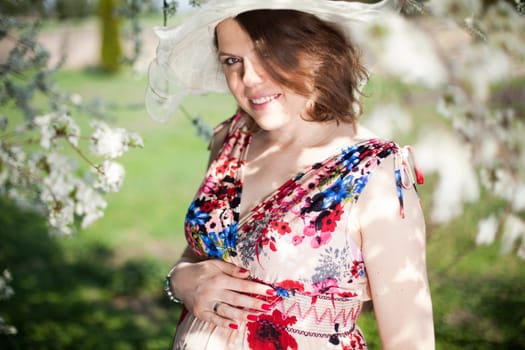 Spring, Young beautiful pregnant woman in the Orchard