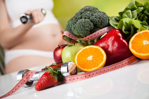 Pregnant woman with fruit and vegetables