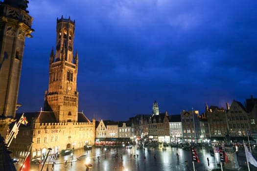 BRUGES, BELGIUM - NOV 7, 2015: Buildings on the Medieval Market Square in Bruges at night on Nov 7, 2015. .