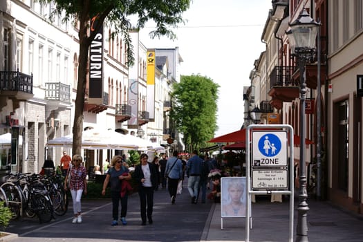 Bad Homburg,Germany - May 19,2018: Passers-by and pedestrians in a shopping street in the city center with department stores,shops and shops on May 19,2018 in Bad Homburg.