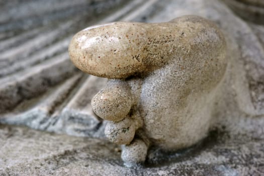 The restored toes and feet of a sandstone sculpture.