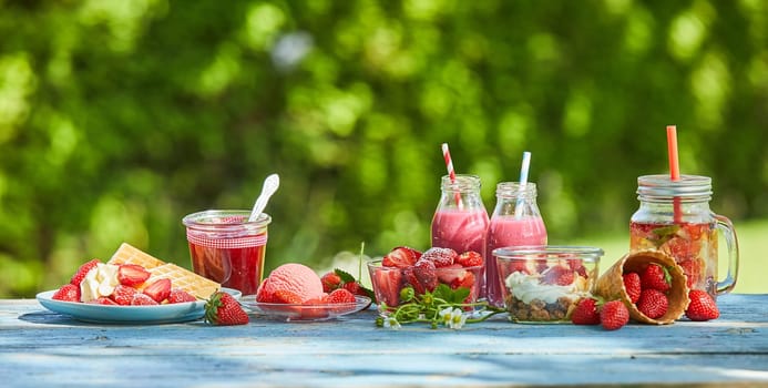 Fresh, healthy, vibrant summer berry smoothie bowls and juices on a bright outdoor table setting.