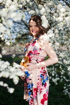 Spring, Young beautiful pregnant woman in the Orchard