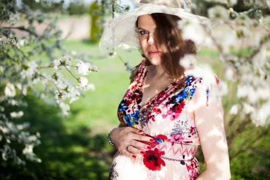 Spring, Young beautiful pregnant woman in the Orchard