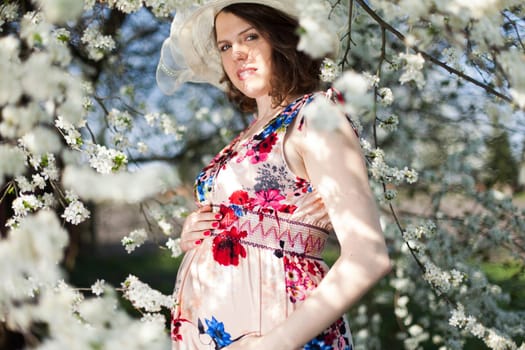Spring, Young beautiful pregnant woman in the Orchard