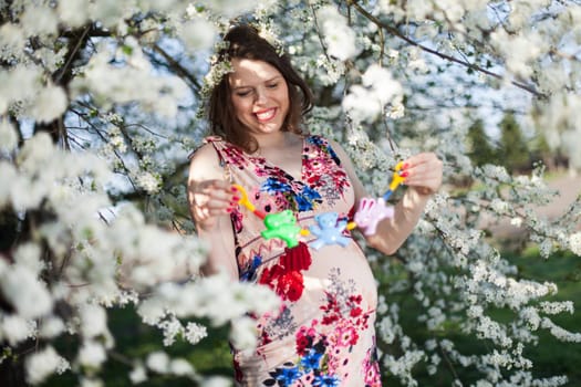 Spring, Young beautiful pregnant woman in the Orchard