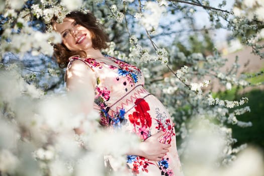 Spring, Young beautiful pregnant woman in the Orchard
